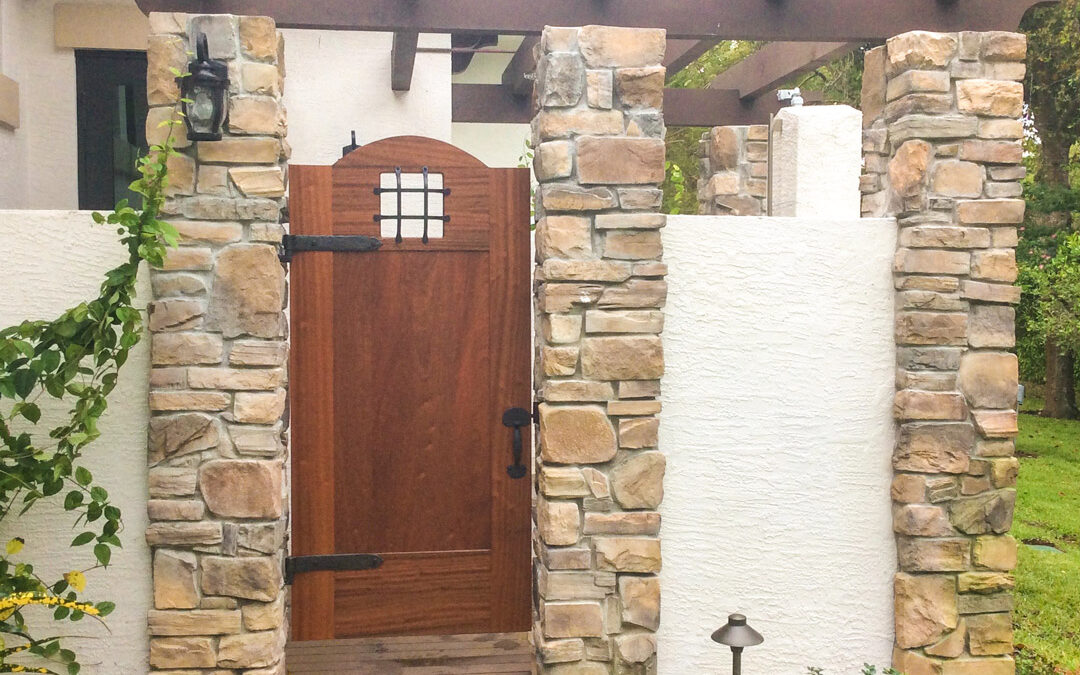 Rustic stone and wood exterior entryway with exposed beams and craftsman-style door.