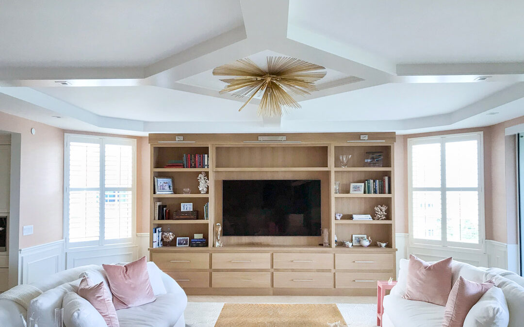 Custom built-in cabinetry and coffered ceiling in a cozy living room interior.