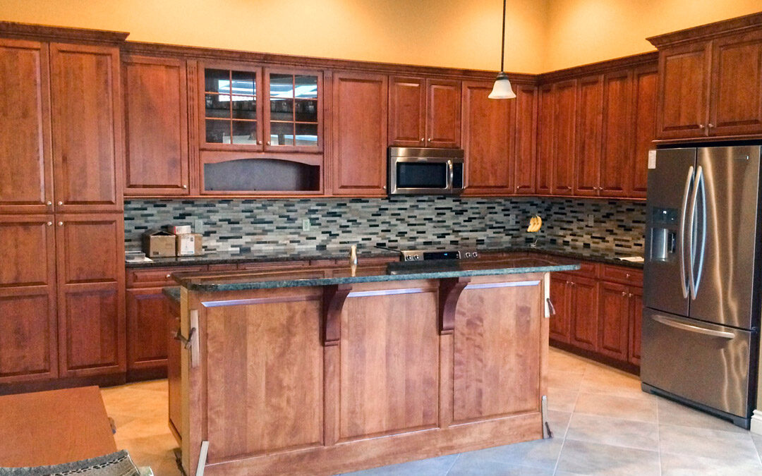 Renovated kitchen featuring cherry wood cabinets, tile flooring, and a large island.