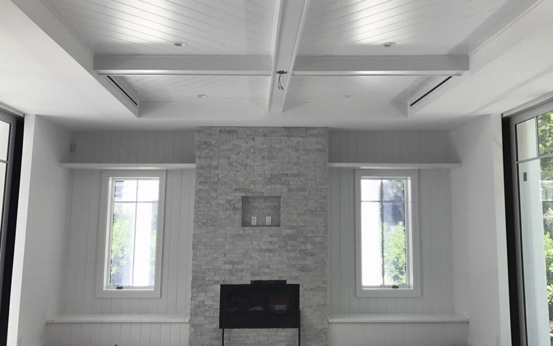 Bright modern living room with vaulted ceilings and stone fireplace